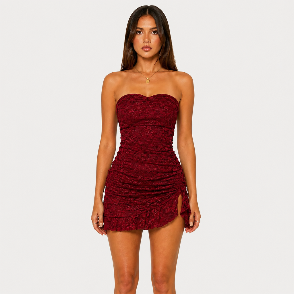 Woman wearing a strapless burgundy dress on a plain background