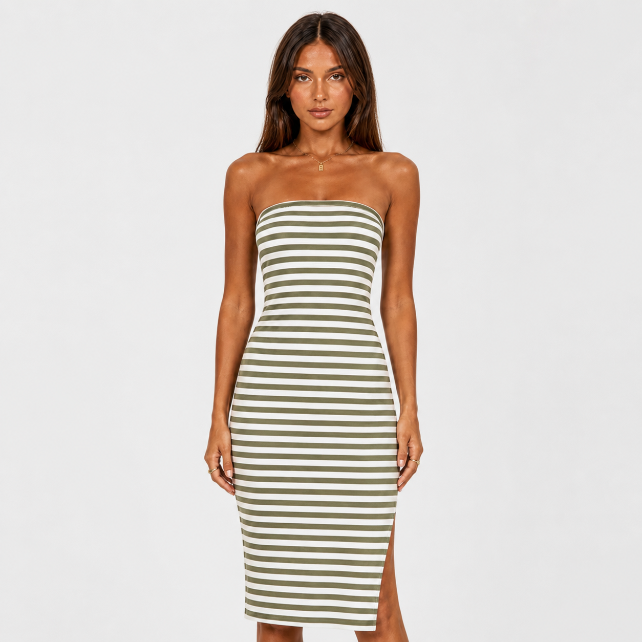 Woman wearing a strapless striped dress on a white background