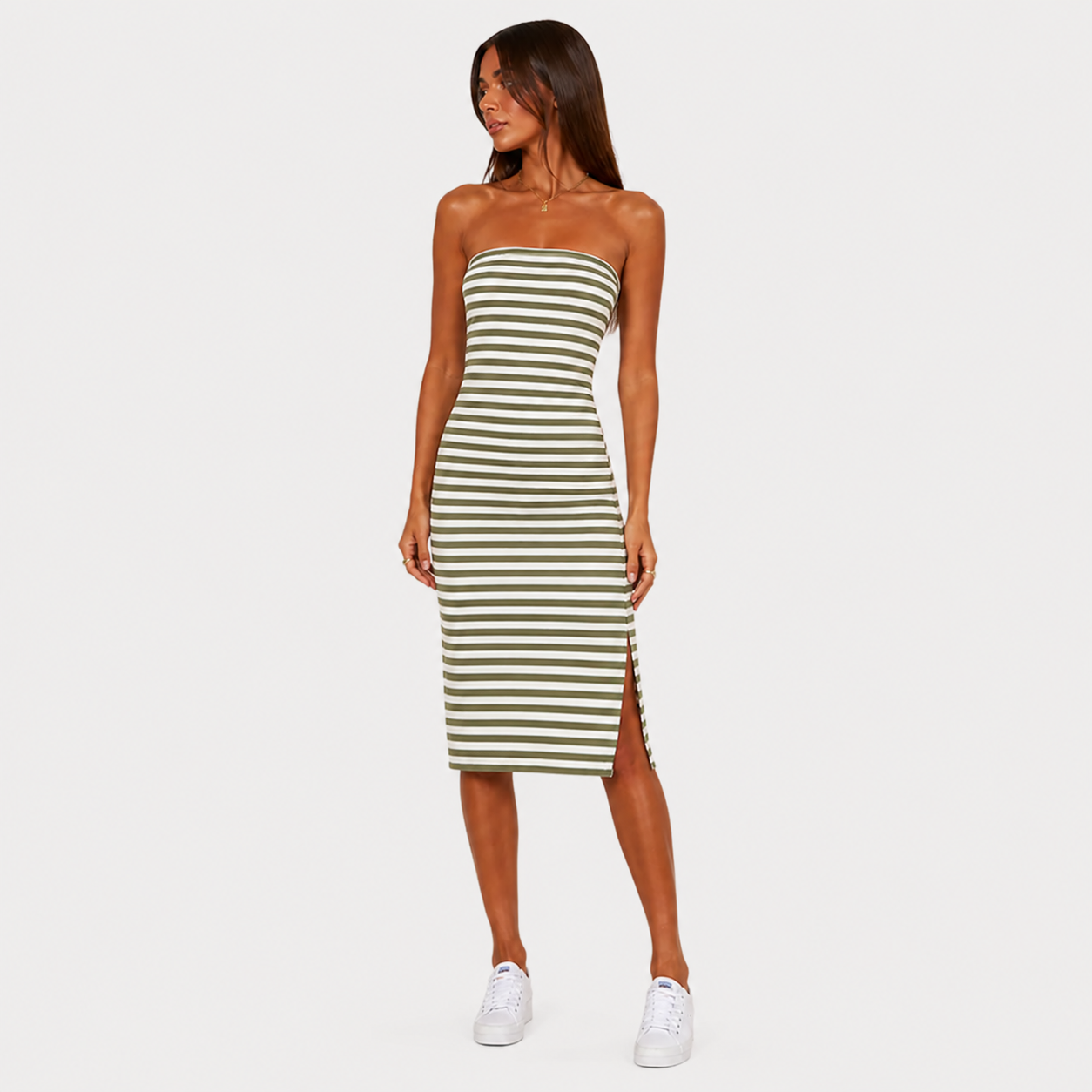 Woman wearing a green and white striped dress on a white background
